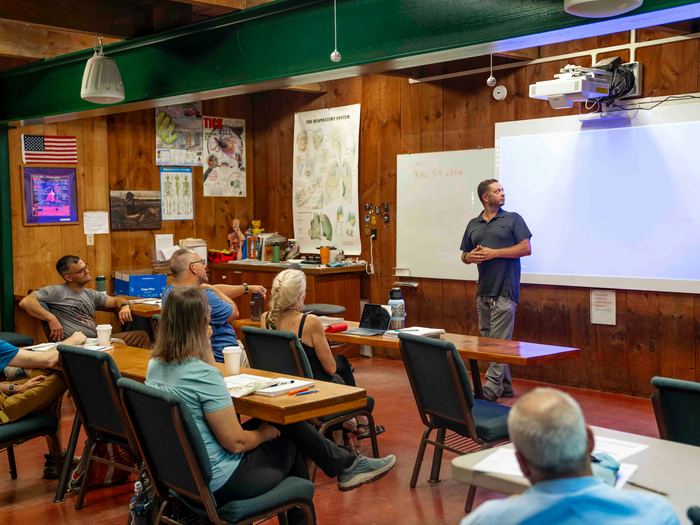 An audience listening to a presentation in a community room